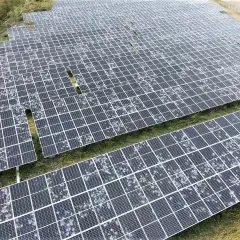Champ de panneaux solaires recouverts de grêle, montrant la résilience de l'énergie renouvelable face aux intempéries.