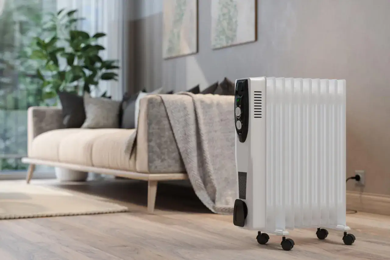 Un radiateur &eacute;lectrique blanc sur roulettes dans un salon moderne. Un avis sur ce type de chauffage &eacute;lectrique est le bienvenu.
